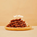 Stack of beef lollipops on a wooden plate with 'Beef Lollipops' text on a beige background