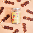 Jar of beef treats with treats on sticks arranged around it on a peach background