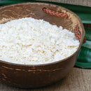 Brown bowl filled with white rice on a textured surface