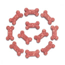Pink bone-shaped dog treats arranged in a circular pattern on a white background