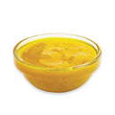 Clear glass bowl filled with yellow liquid on a white background