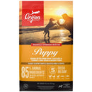 Orijen Puppy dog food package with sunset beach scene and silhouette of a dog.
