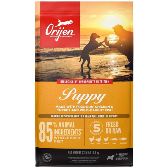 Orijen Puppy dog food package with sunset beach scene and silhouette of a dog.
