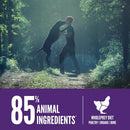 Two people in a forest with a promotional banner about animal ingredients and a whole prey diet.