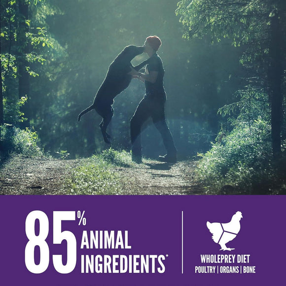 Two people in a forest with a promotional banner about animal ingredients and a whole prey diet.