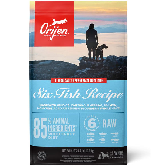 Orijen dog food package with a scenic background and silhouette of a person and dog.
