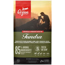 Orijen Tundra dog food package with a silhouette of a person and dogs against a sunset background.
