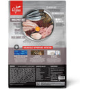 Orijen pet food package with a plate of raw meat and fish on a gray background