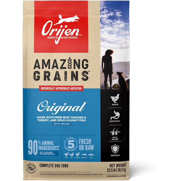 Orijen dog food package with a woman and dog on a mountain background