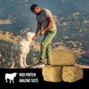 Man and dog on a mountain with protein bars and 'High Protein Amazing Taste' text overlay