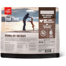 Orijen dog treats packaging with a person and dog on a beach