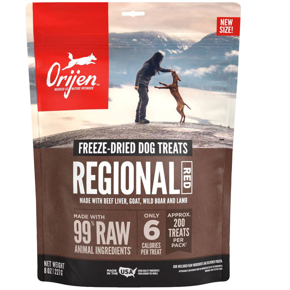 Orijen Regional Red freeze-dried dog treats packaging with a scenic background