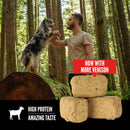 Man and dog in a forest with stacked blocks of pet food and text about more venison content.