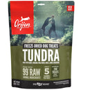 Orijen Tundra freeze-dried dog treats packaging with a man and dog in a forest background.