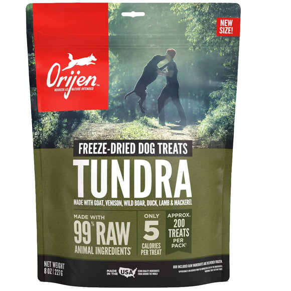 Orijen Tundra freeze-dried dog treats packaging with a man and dog in a forest background.