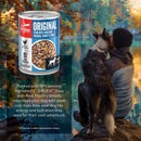 Orijen dog food can with a person and dog sitting by a lake