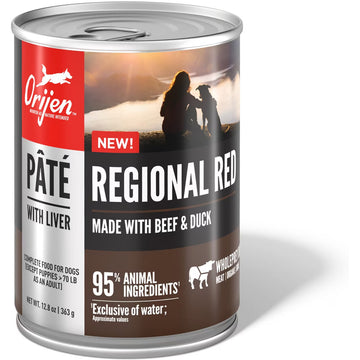 Orijen Regional Red dog food can with a sunset silhouette design on the label.