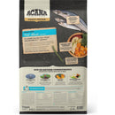 Acana pet food packaging with images of fish and vegetables on a black background