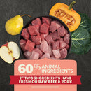 Raw beef cubes in a bowl with vegetables and a label highlighting ingredient information on a dark background.