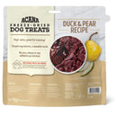 Acana freeze-dried dog treats packaging with duck and pear recipe on a marble background
