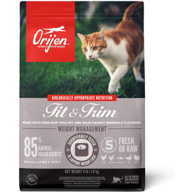 Orijen Fit & Trim cat food package with a cat on grass in the background