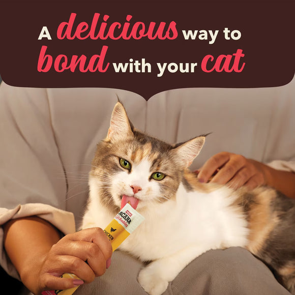Cat eating from a treat held by a person with text 'A delicious way to bond with your cat' on a brown background