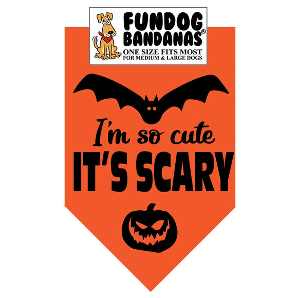 Halloween-themed dog bandana with bat, pumpkin, and text 'I'm so cute IT'S SCARY' on an orange background.