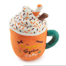 Plush toy resembling a pumpkin spice latte with whipped cream and sprinkles on a white background