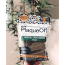 Package of PlaqueOff dental care bones for dogs with a plant in the background