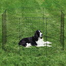 Dog inside a black metal playpen on grass