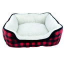 Pet bed with red and black checkered pattern and white interior on a white background