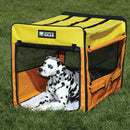 Dog sitting inside a yellow and orange Guardian Gear pet crate on grass