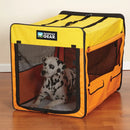 Dog inside a yellow and orange Guardian Gear pet crate on a wooden floor.