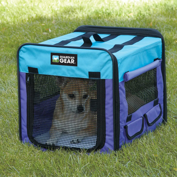 Pet carrier with a dog inside on grass, featuring the Guardian Gear brand.