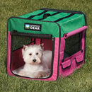 Dog inside a green and pink Guardian Gear pet crate on grass