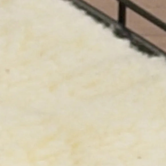 Close-up of a textured beige surface with a brown border