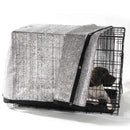 Dog crate with a black and white patterned cover on a white background