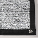 Textured black and white fabric with a grommet on a white background