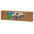 Box packaging of a pet cot with a pug on a wooden floor
