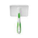 White pet grooming brush with green handle on a white background