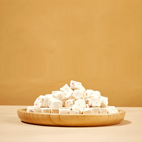 Wooden plate with white cubes on a beige background