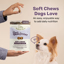 Bag of Badlands Ranch Super Skin & Coat Soft Chews for dogs with a dog looking at the camera and a hand holding a soft chew.