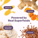 Superfoods like salmon oil, turmeric, lion's mane mushroom, and flaxseed with text 'Powered by Real Superfoods' on a white background.