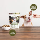 Dog food topper package with a dog and treats on a wooden surface