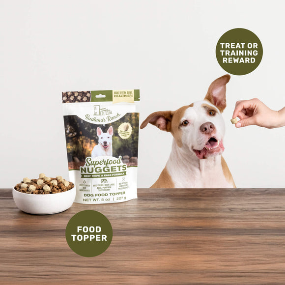 Dog food topper package with a dog and treats on a wooden surface