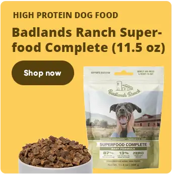 A bag of badlands ranch superfood complete dog food, featuring a cheerful brown and white dog on the packaging with kibble visible in front.