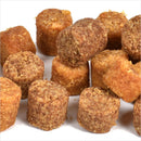 Pile of small, round, brown food items on a white background