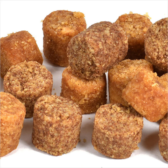 Pile of small, round, brown food items on a white background
