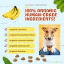 Dog food product with organic ingredients listed and a dog sitting on a person's lap.