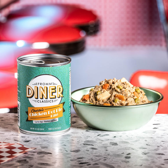 Can of Diner Classics pet food with a bowl of food on a checkered tablecloth.